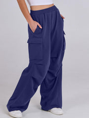 Royal blue sweatpants with cargo pockets and a wide leg, shown on a model.