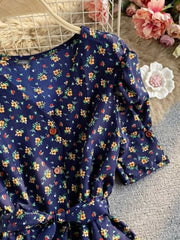 Dark blue floral V-neck midi dress with button front and belted waist.