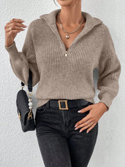 Taupe ribbed zip-up knit sweater with a collar and gold zipper detail.