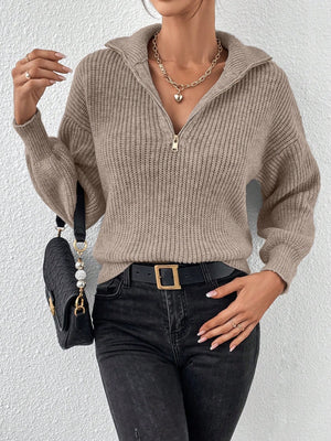 Taupe ribbed zip-up knit sweater with a collar and gold zipper detail.