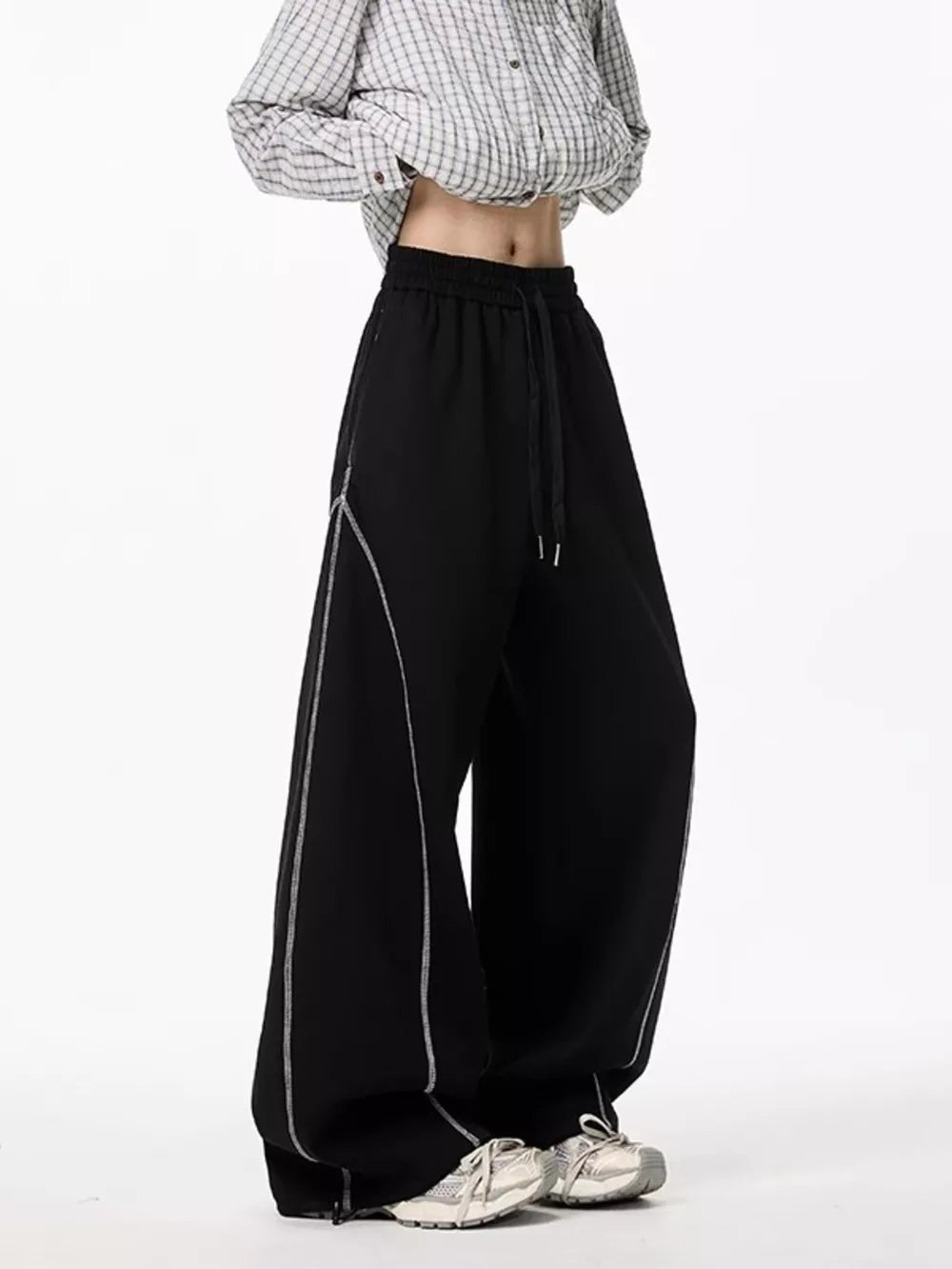 Black wide-leg drawstring sweatpants with contrast stitching detail.