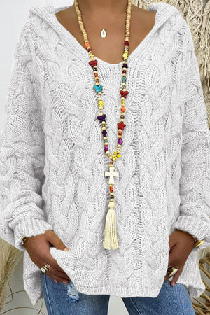 White cable knit hooded cocoon sweater with V-neck and long sleeves.