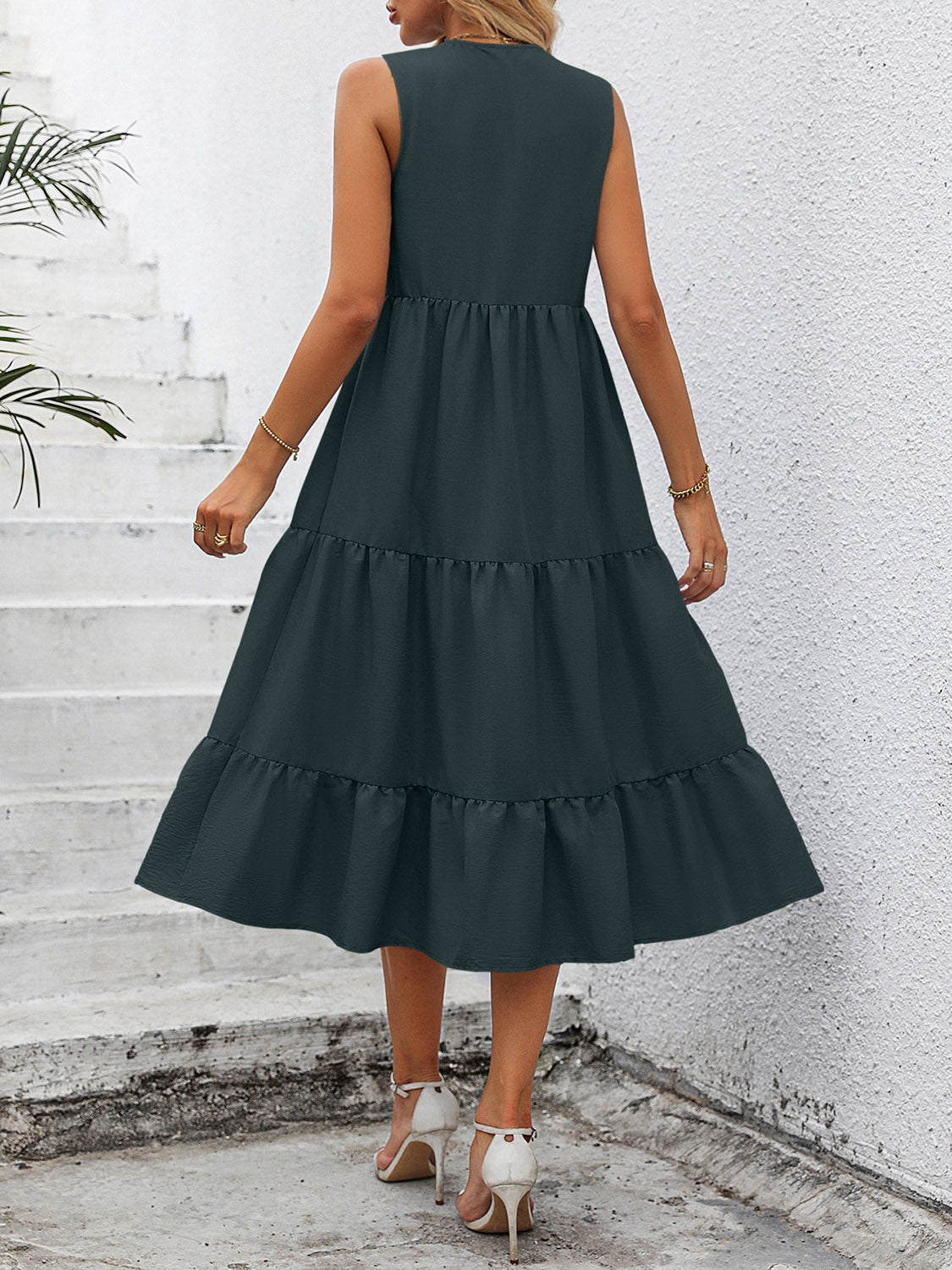 Dark green sleeveless midi dress with tiered skirt and button-down detail.