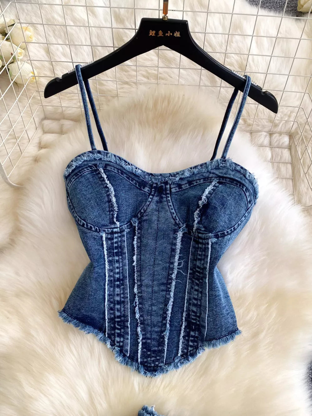 Denim cami top with raw hem and distressed details.