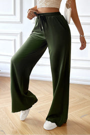 Matcha green textured rib wide-leg drawstring trousers with pockets.