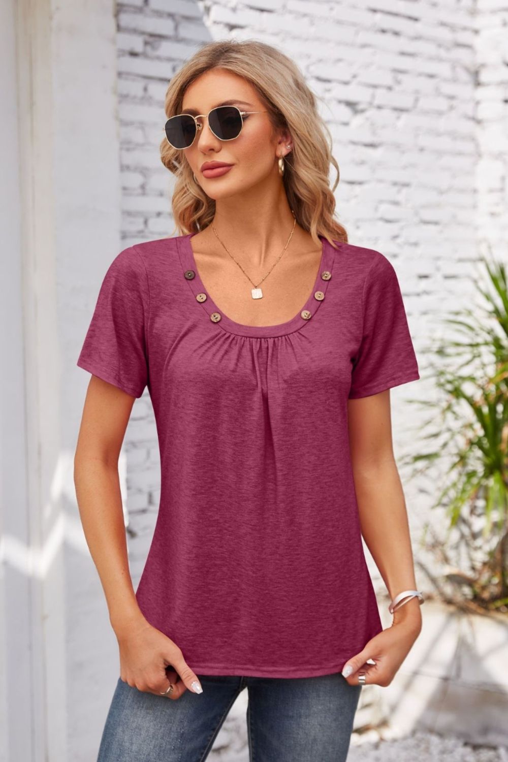 Button-trimmed gathered yoke top in watermelon pink with short sleeves and a scoop neckline.