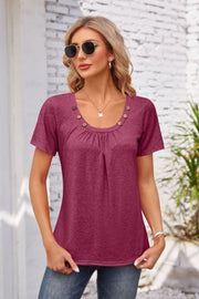 Button-trimmed gathered yoke top in watermelon pink with short sleeves and a scoop neckline.
