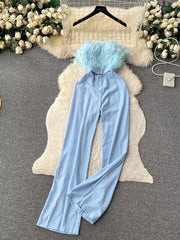 Blue strapless wide-leg jumpsuit with feather trim and belted waist.