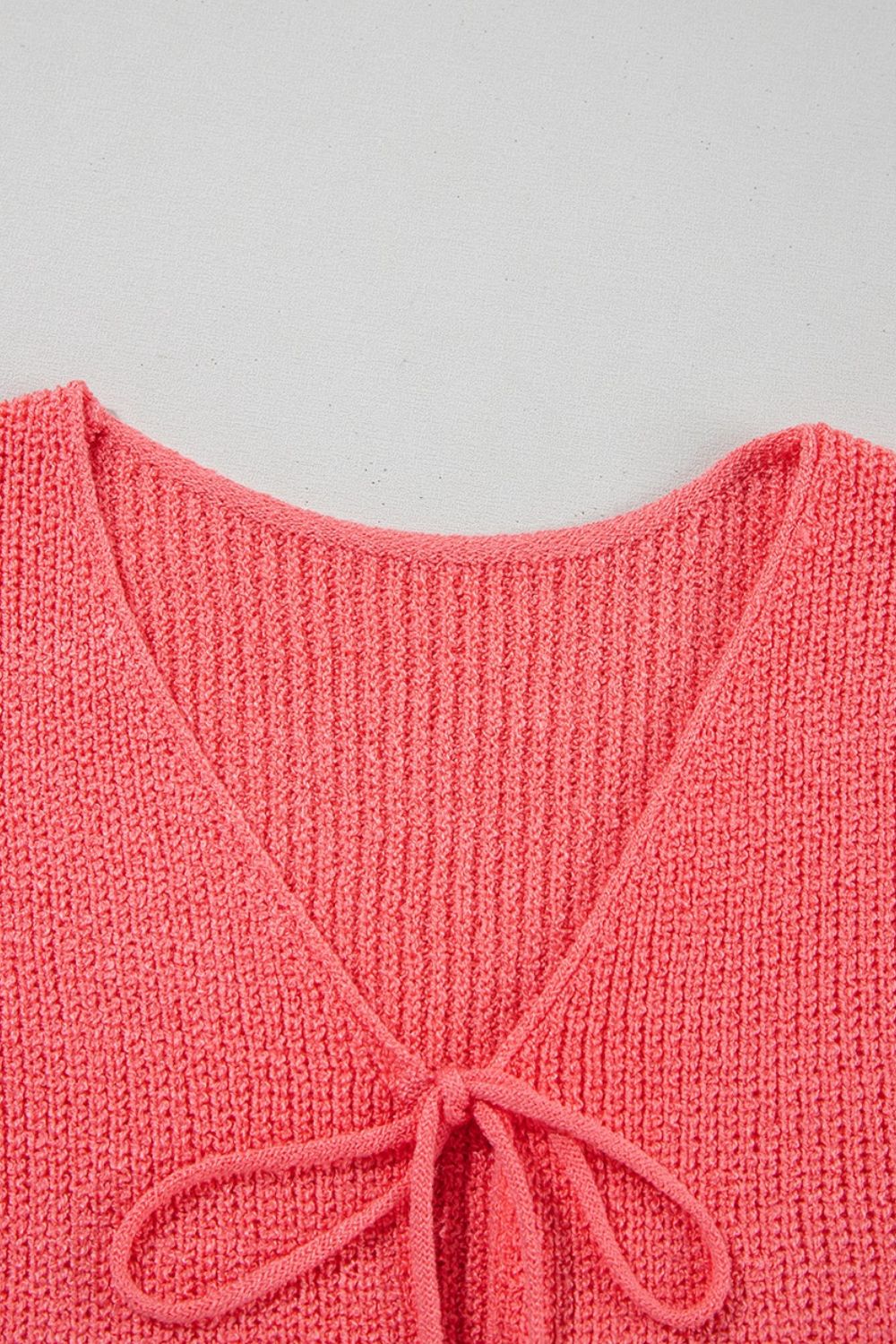 Burnt Coral textured knit tank top with tie-front detail and V-neckline.