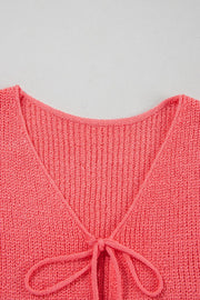 Burnt Coral textured knit tank top with tie-front detail and V-neckline.