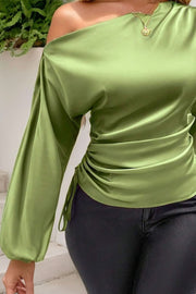 Matcha green satin blouse with asymmetric neckline, ruched side detail, and balloon sleeves.