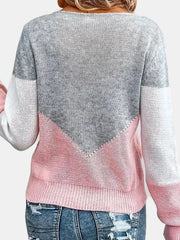 Colorblock knit sweater in pink and gray with a V-shaped yoke detail.