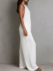 White halter neck wide leg romper with deep armholes and flowy pants.