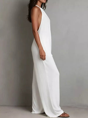 White halter neck wide leg romper with deep armholes and flowy pants.