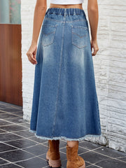 Faded blue denim midi skirt with frayed hem and elastic waistband.
