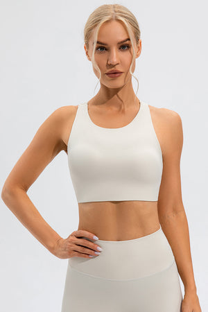 Camel sports bra with asymmetric cutout detail and racerback.