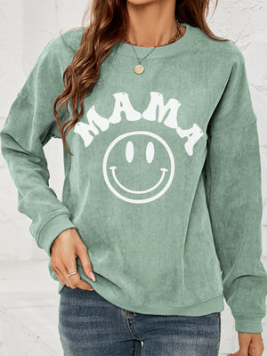 Corduroy sweatshirt in Gum Leaf with white "Mama" smiley graphic.