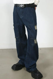 Dark wash denim wide-leg jeans with distressed panel pockets and a casual fit.