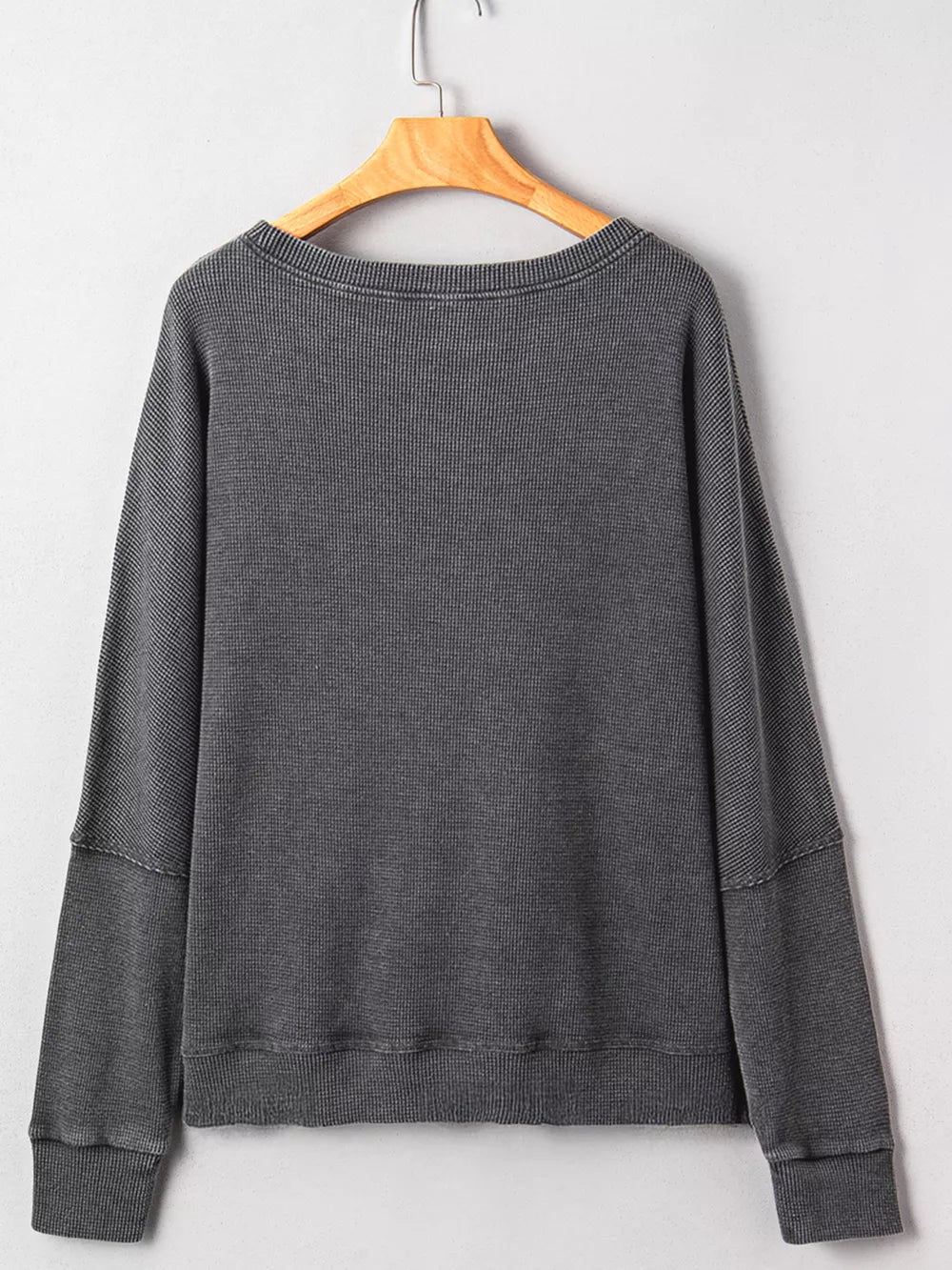Dark gray waffle knit oversized sweatshirt with crew neck and long sleeves.