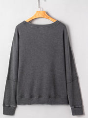 Dark gray waffle knit oversized sweatshirt with crew neck and long sleeves.