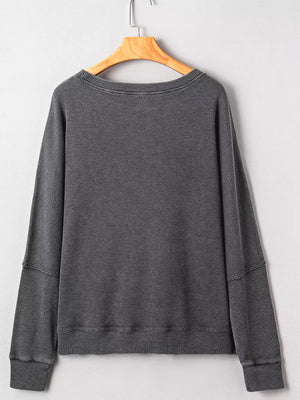 Dark gray waffle knit oversized sweatshirt with crew neck and long sleeves.
