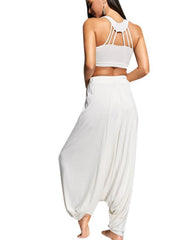 White drape-front drawstring harem pants with a relaxed fit and elastic waistband.