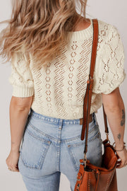 Cream lace-effect knit top with puff sleeves and diamond pattern detail.