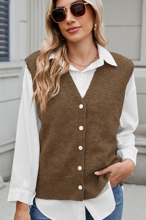 Button-front knit vest in taupe with V-neck and shoulder detail, acrylic fabric.