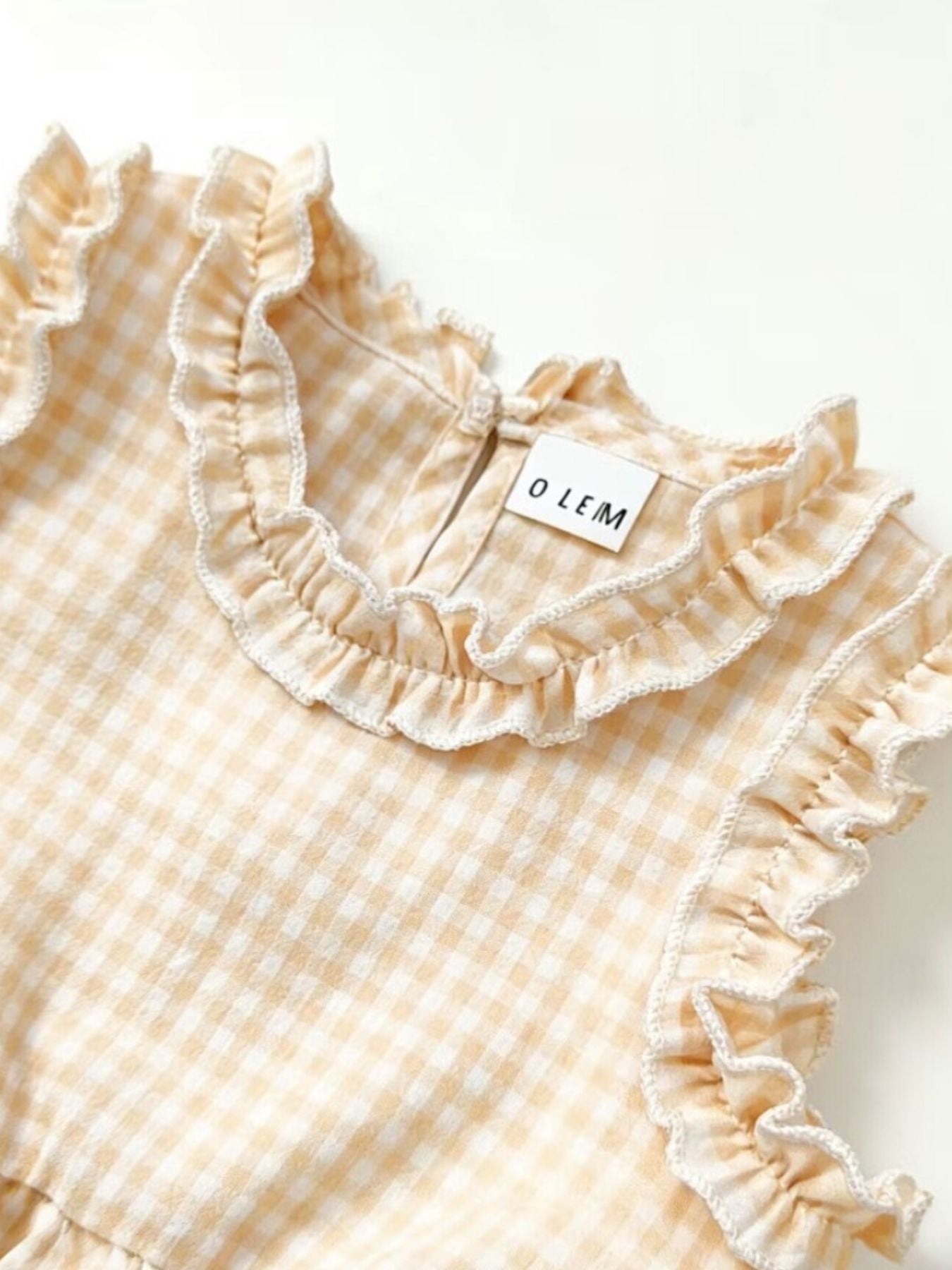 Children's yellow gingham cotton top with ruffled neckline and sleeves