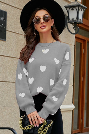 Gray knit sweater with white heart pattern and balloon sleeves.