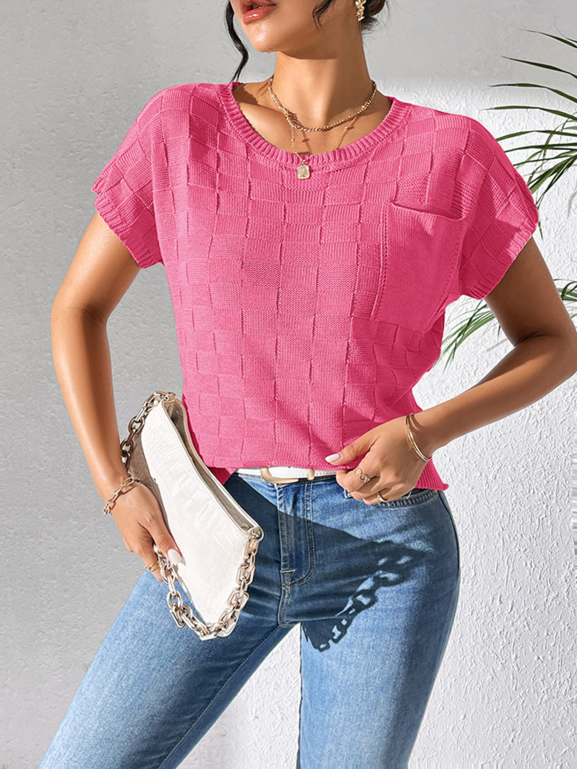 Textured knit pocket tee in bright pink with short sleeves and crew neck.