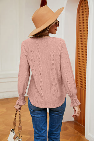 Blush pink eyelet blouse with lace trim and ruffle cuffs.