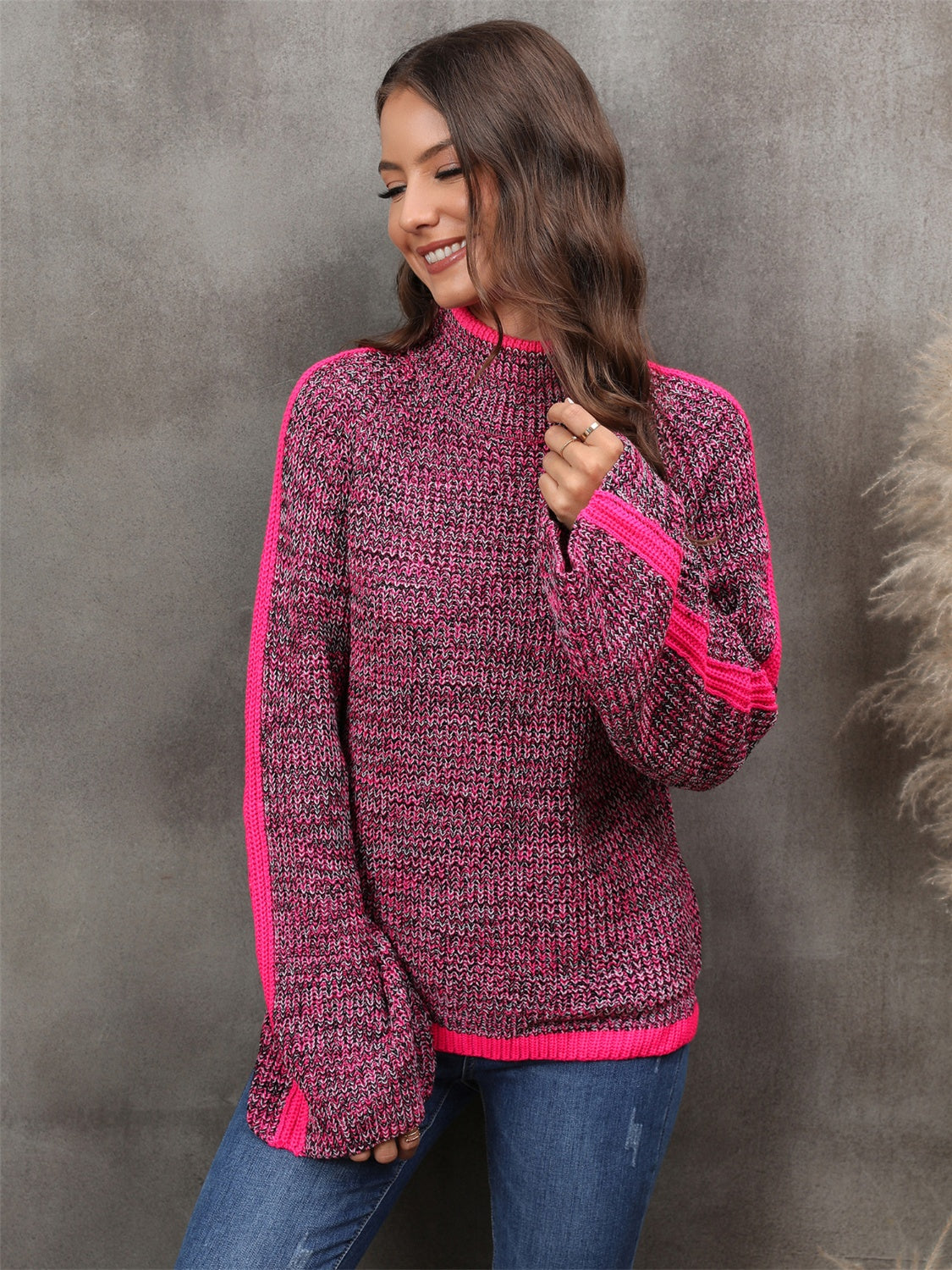 Colorblock raglan sleeve turtleneck knit sweater in cerise with pink accents.