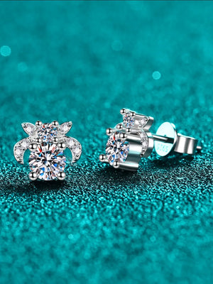 Silver moissanite floral cluster stud earrings with sparkling round-cut center stones and smaller accent gems.
