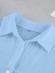 Light blue textured cotton button-up shirt with a collared neckline.