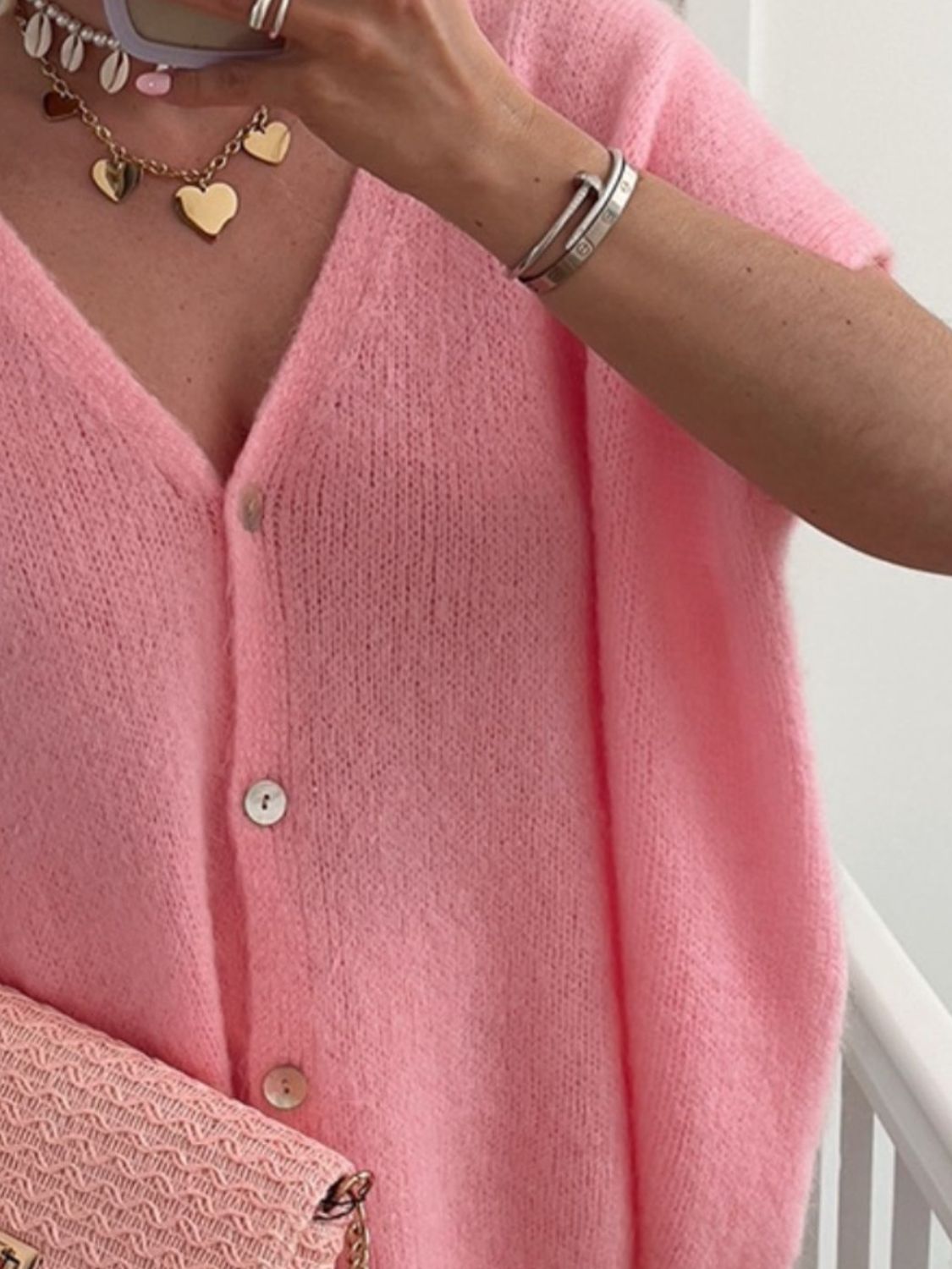 Pink mohair blend cardigan with cap sleeves and button front.