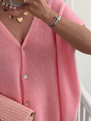Pink mohair blend cardigan with cap sleeves and button front.
