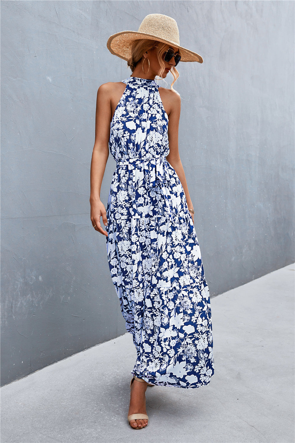 Blue floral print halter neck maxi dress with a tie waist.