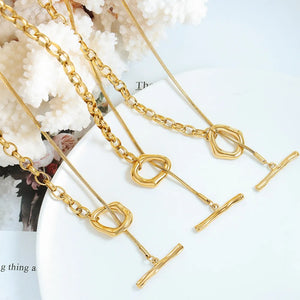 Gold asymmetrical chain and bar necklaces with toggle closure detail