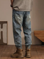 Relaxed fit light wash denim jeans with vintage fade and panel detailing.