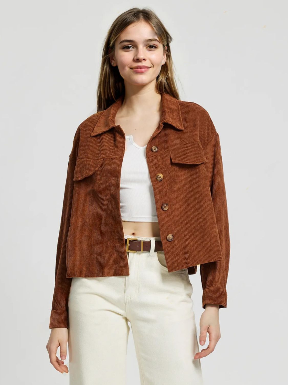 Brown corduroy utility jacket with button front and patch pockets.