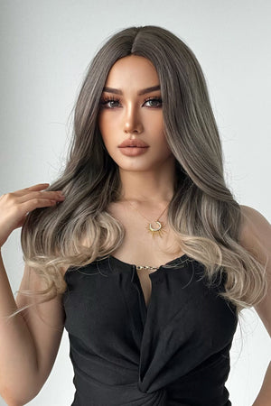 Ombre wave synthetic wig in ash brown to blonde, styled with loose curls.