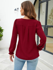 Burgundy textured blouse with pleats and ruffle cuffs, long sleeves