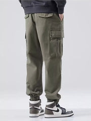 Plus-size relaxed fit cargo sweatpants in Army Green with multiple pockets and cuffed ankles.