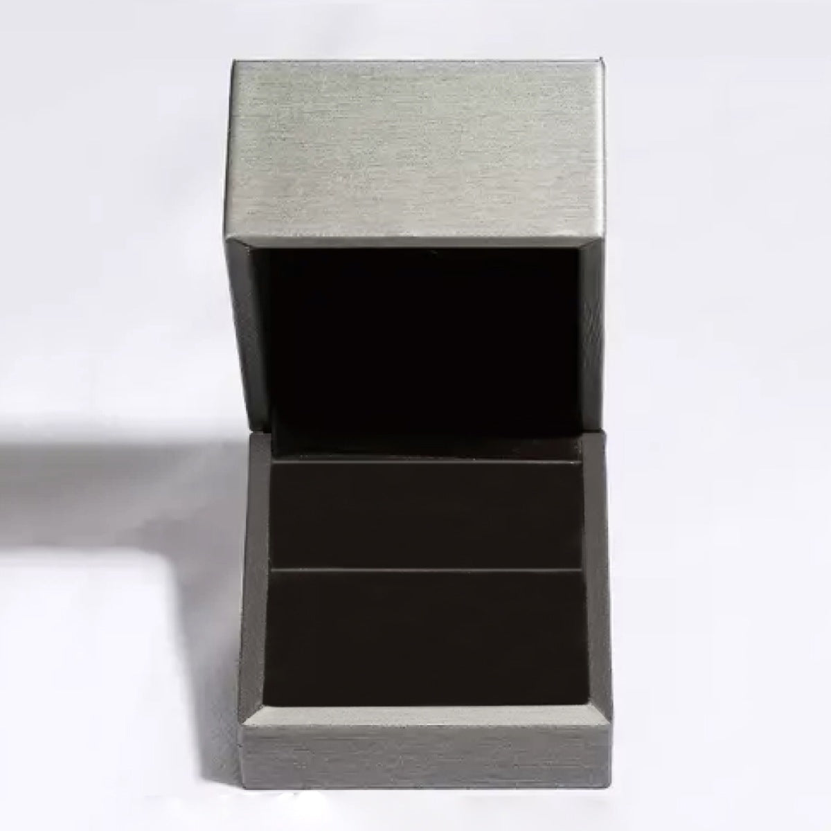 Moissanite Sterling Crossover Ring jewelry box, open, gray exterior, black interior.