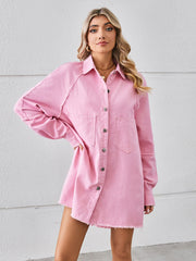 Pink denim shirt dress with raw hem, button front, and chest pockets.