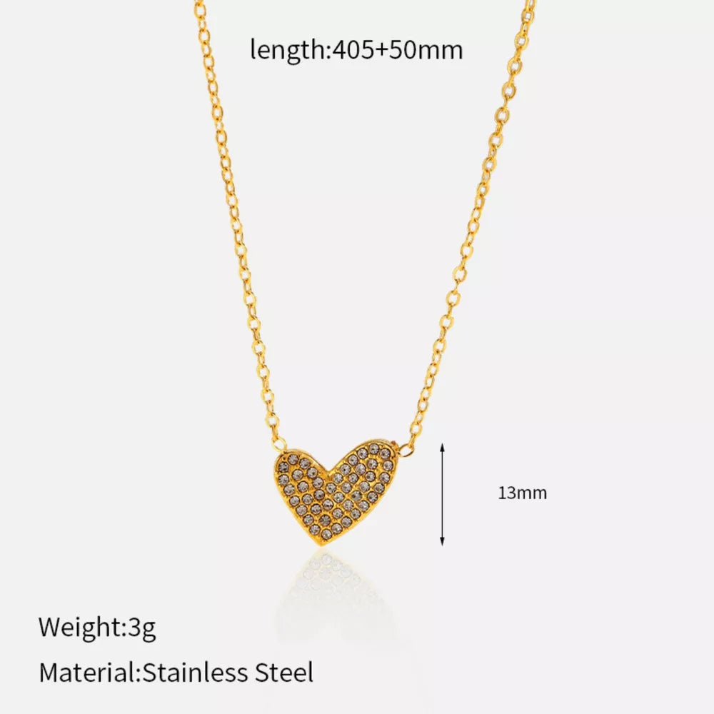 Gold heart pendant necklace with rhinestones and delicate chain.
