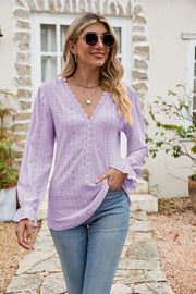 Lavender eyelet lace blouse with ruffle sleeves and V-neckline.