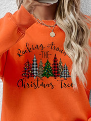 Orange crewneck sweatshirt with graphic Christmas trees and text.