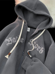 Gray zip-up hoodie with white gothic text graphic and drawstring hood